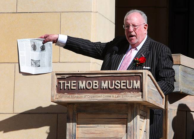 Former Las Vegas Mayor Oscar Goodman holds up a news article with a story on The Mob Museum during the museum's grand opening in downtown Las Vegas, Tuesday February 14, 2012. Goodman is also known as a former mob attorney for representing alleged mobsters such as Meyer Lansky, Frank Rosenthal and Anthony Spilotro.