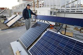 Robert Boehm, director for the Center for Energy Research at UNLV, stands by a variety of photovoltaic panels used for teaching on the roof of the engineering building at UNLV Wednesday, Feb. 22, 2012.