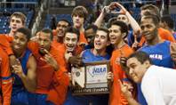 Bishop Gorman players gather around the 4A state championship trophy after defeating Northern Nevada's Hug High 96-51 at Lawlor Events Center in Reno.