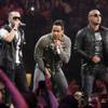 Romeo Santos, center, performs with Yandel, left, and Wisin, right, of reggaeton duo Wisin y Yandel, during a concert at Madison Square Garden, Friday, Feb. 24, 2012 in New York. 
