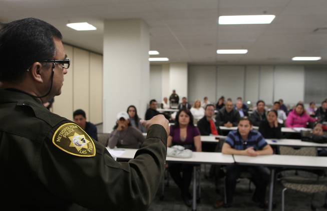 Metro Officer David Cienega, director of the Hispanic Citizen's Academy, gives directions to those gathered for an orientation session at Metro headquarters Feb. 29, 2012. The 11-week, Spanish-language course teaches students about their rights as Nevada residents and how to work with police in combating crime.