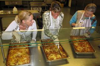 Volunteers prepare lasagna for residents of the Las Vegas Rescue Mission and the homeless for their monthly 