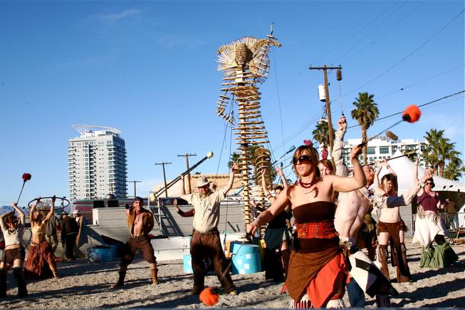 Workers and performers prepare for the burn of "Lucky Lady Lucy" in downtown Las Vegas on Friday, March 2, 2012. 