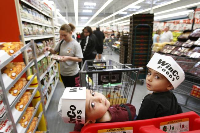 Three-year-old twins Armann, left, and Aryan Saadi wear Winco hats as their mother shops during the grand opening a WinCo Foods supermarket at Stephanie Street and Wigwam Parkway in Henderson Sunday, March 4, 2012. The Boise-based supermarket chain opened their 81st and 82nd stores Sunday, their first stores in Southern Nevada. STEVE MARCUS