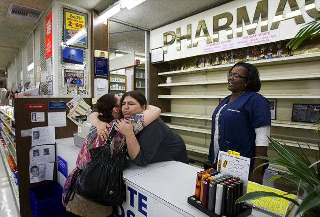 Vicki Kelesis, a waitress at Tiffany's Cafe, gives a hug to pharmacy technician Mandy Tucker, as co-worker Sharron Manzy looks on during the last day of operation at the White Cross Pharmacy on Las Vegas Boulevard South Tuesday, March 6, 2012. The pharmacy, the first 24-hour pharmacy in Las Vegas, opened in 1955 but closed at 7 p.m. Tuesday night.
