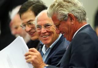 Singer Jimmy Buffett, center, prepares for a Gaming Control Board hearing at the Sawyer State Building Wednesday, March 7, 2012. With Buffett are attorney Jeffrey Smith, left, and John Cohlan of Margaritaville Holdings.