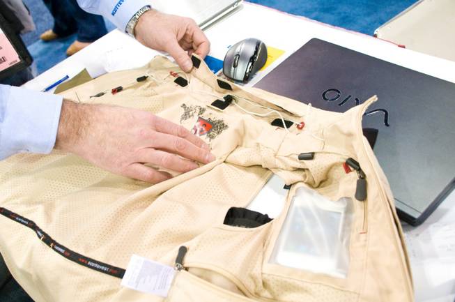 The multi-pocketed Scottevest, which has 24 internal pockets helps the ...