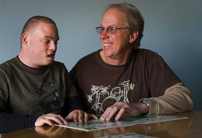 Donald Munn spends time with his disabled adopted son Brian, 21, at their home in Henderson Thursday, March 8, 2012. Munn, a former Clark County firefighter, says the fire department fired him for abusing sick leave but Munn says he needed to take the sick leave to care for his son. Brian Munn suffers from fetal alcohol syndrome.