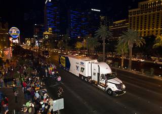 Matt Kenseth's car hauler passes fans in front of Bally's during a NASCAR hauler parade on Las Vegas Boulevard Thursday, March 8, 2012.