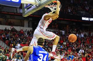 New Mexico guard Kendall Williams hangs on the rim after a dunk against Air Force during their Mountain West Conference Tournament game Thursday, March 8, 2012.  Williams incurred a technical foul for hanging on the rim.