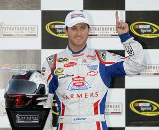 Kasey Kahne poses for photos following qualifying for Sunday's NASCAR Sprint Cup Series auto race, Friday, March 9, 2012, in Las Vegas. Kahne won the pole position with speed of 190.456 mph.