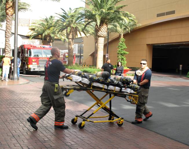 Las Vegas firefighters roll equipment toward the Golden Nugget on Thursday morning. An unidentified man was in critical condition after a fire in a room on the 22nd floor of the Rush Tower.