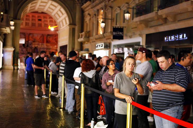 Customers line up to purchase the new iPad at the Apple Store inside the Forum Shops at Caesars in Las Vegas on Friday, March 16, 2012.
