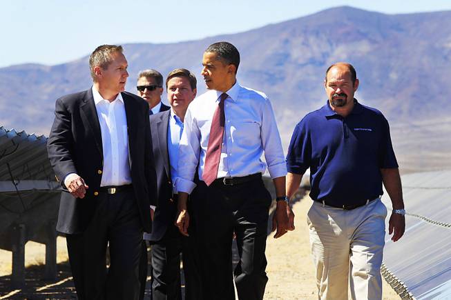 President Barack Obama walks with Sempra U.S. Gas & Power's, from left, CEO Jeff Martin, Vice President Operations John Sowers and Kevin Gillespie, right, while touring their Copper Mountain Solar 1 photovoltaic plant Wednesday, March 21, 2012 south of Boulder City.