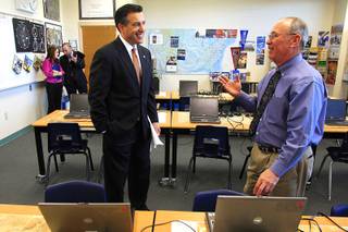 Governor Brian Sandoval speaks with Rancho High School aviation teacher Bob Hale Thursday, March 22, 2012 while looking at aviation education in Southern Nevada.