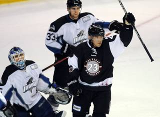 Idaho players look on as Judd Blackwater (23) holds his stick up in celebration after scoring his 19th goal of the season during the first period of play against the Steelheads on Friday night, March 23, 2012, at the Orleans Arena. 