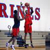 Findlay Prep's Christian Wood shoots over Winston Shepard during practice at the Henderson International School campus Monday, March 26 2012.