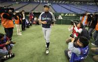 Japanese journalists focus their cameras on Seattle Mariners' Ichiro Suzuki before his team's practice at Tokyo Dome in Tokyo Tuesday, March 27, 2012. The Mariners will meet the Oakland Athletics in their two season-opening games of the Major League Baseball in Japan, at Tokyo Dome from Wednesday.