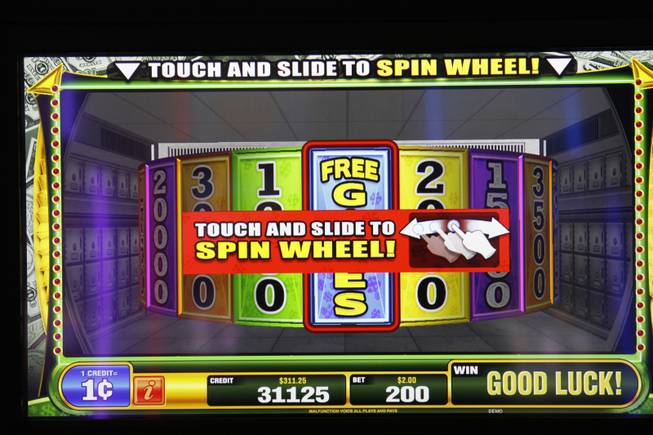 A screen displays a wheel on a Money Vault video slot machine by Bally Technologies Thursday, March 29, 2012.