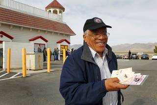 Reinaldo Nunley, a Greyhound bus driver, displays his 56 Mega Millions lottery tickets at the Primm Valley Lotto Store across the state line at Primm Thursday, March 29, 2012. Nunley said he bought 56 tickets because 56 is a lucky number for him. 