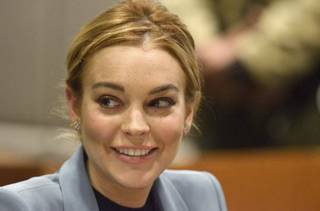 Lindsay Lohan smiles in court during a progress report on her probation for theft charges at Los Angeles Superior Court Thursday, March 29, 2012. Lohan will update a judge on her progress on strict probation requirements that have had her doing cleanup duty at the county morgue and attending regular psychotherapy sessions since late last year. Superior Court Judge Stephanie Sautner has said she will end Lohan's probation on a 2007 drunken driving case on Thursday if she completes the requirements.