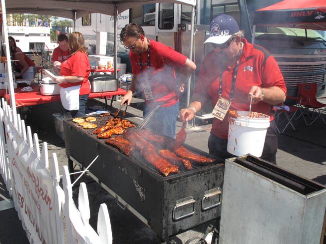 Competitors prepare ribs and chicken as part of the BBQ Throwdown challenge at Mandalay Bay Saturday. The competition was part of the Academy of Country Music Experience, which took over Mandalay's Bay convention center this weekend for three days of shopping, music and food.