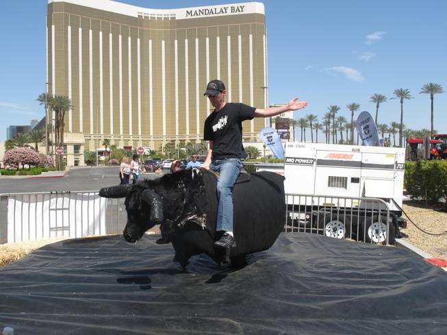 Patrick O'Connell, who was visiting Las Vegas from Canada, rides a mechanical bull during the Academy of Country Music Experience. The event, which took over the Mandalay Bay convention center, runs through Sunday and offers fans a chance to shop, eat and listen to live country music.