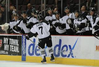 ECHL First Team All-Star Eric Lampe (7) skates along the front of the Las Vegas bench after scoring a goal for the 37th time this season, one more time than any other Wrangler in team history, Friday night, March 30, 2012, during his team's 6-4 victory over Colorado.