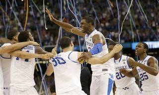 Kentucky's Terrence Jones, center, celebrates with teammates after the NCAA Final Four tournament college basketball championship game against Kansas Monday, April 2, 2012, in New Orleans. Kentucky won 67-59.