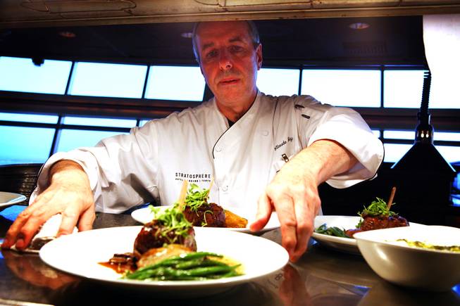 Chef Claude Gaty prepares a dish for service at the Top of the World Restaurant at the Stratosphere on Thursday, April 5, 2012.