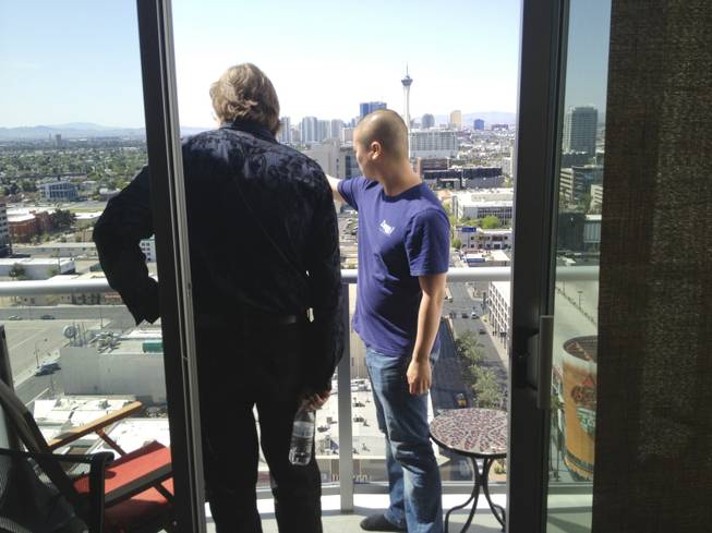 From his 23rd floor condo, Tony Hsieh points out various targets of redevelopment for his Downtown Project, a $350 million, multi-year endeavor, to Ed Lantz, CEO of Vortex Immersion Media.
