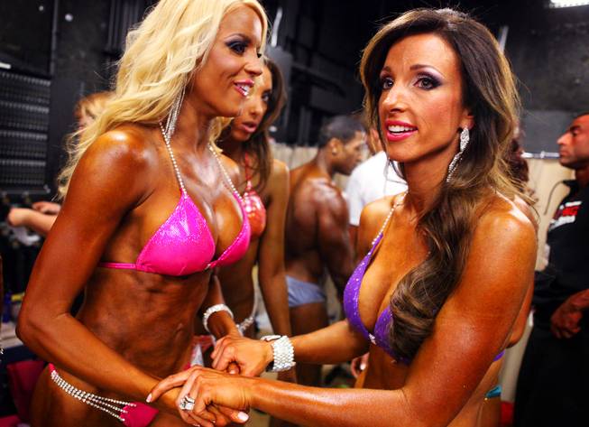 Dee's Divas Ruth Gray, left, and April Swartz, both of Las Vegas, wait to walk the stage in the bikini comeptition during the Jay Cutler Desert Classic at the Palms on Saturday, April 7, 2012.