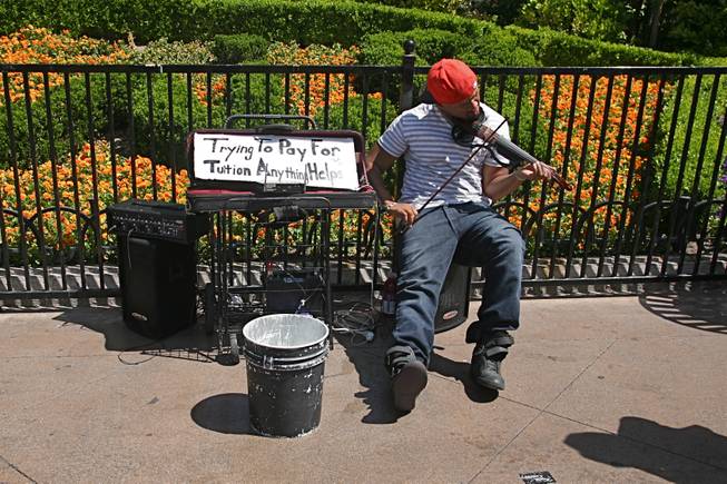 Musician Anthony Williams performs for passersby on the Strip on Saturday, April 7, 2012.