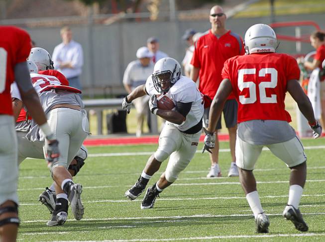 Running back Bradley Randle looks for a hole during practice at UNLV's Rebel Field, April 16, 2012.