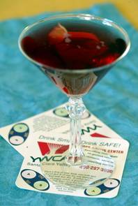 A cosmopolitan cocktail sits atop a date rape drug detection coaster. The coasters have test spots that are supposed to turn dark blue in about 30 seconds if a splash of alcohol contains drugs  often used to incapacitate victims.