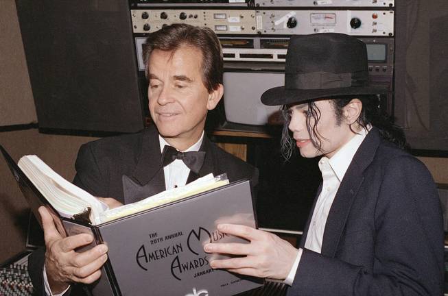 In this Jan. 24, 1993, file photo, American Music Awards executive producer Dick Clark and singer Michael Jackson go over the script during rehearsals for the AMAs at Shrine Auditorium in Los Angeles. Clark, the TV host who helped bring rock 'n' roll into the mainstream on "American Bandstand," died Wednesday, April 18, 2012, of a heart attack. He was 82. 