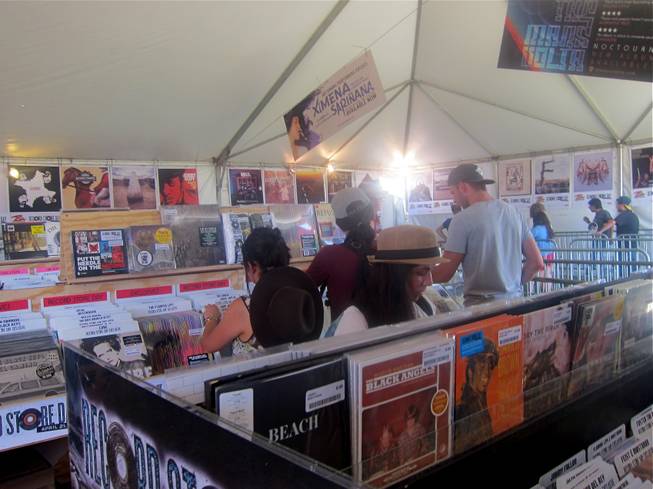 Patrons peruse Zia Records' Record Store Day offerings at the store's pop-up shop at the Coachella Valley Music and Arts Festival on Saturday, April 21, 2012.