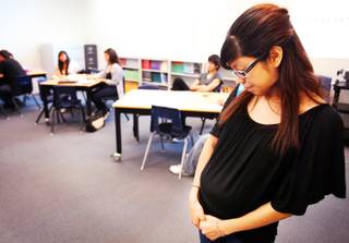 Evaleen Diaz, 18, stops into a class to say hello to her favorite math teacher at Western High School on Thursday, April 26, 2012. Diaz, a senior at Western, is seven months pregnant.