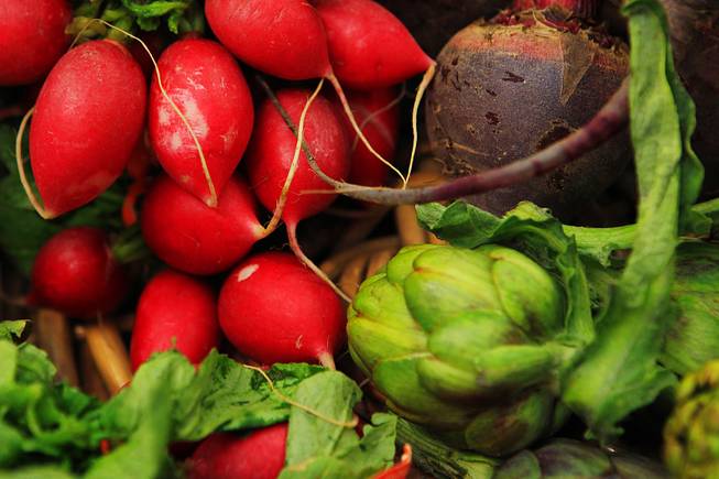 Radishes, beets and artichokes are seen at the farmers market at the Springs Preserve Thursday, April 26, 2012.