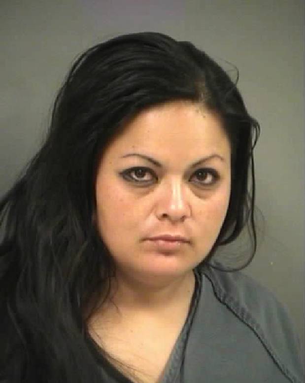Police arrest Ivonne Cabrera in connection with a North Las Vegas shooting that killed two and injured two others, April 27, 2012.