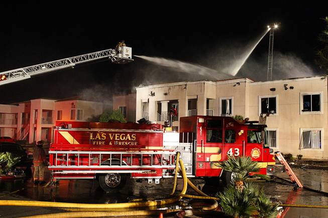 City of Las Vegas firefighters work to control a two-alarm apartment fire at Ashford Manor near Jones Boulevard and Smoke Ranch Road Thursday, May 3, 2012. The 16-unit apartment fire left many units badly damaged, but all residents escaped safely. The fire was determined to be accidental.