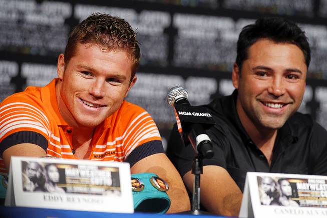 WBC super welterweight champion Canelo Alvarez, left, of Mexico and Golden Boy Promotions president Oscar De La Hoya attend a news conference at the MGM Grand May 3, 2012. Golden Boy is promoting a fight between Alvarez and Victor Ortiz at the MGM Grand Garden Arena on September 15. On the same day, Julio Cesar Chavez Jr., promoted by Top Rank, will defend his WBC middleweight title against Sergio Gabriel Martinez at the Thomas & Mack Center.