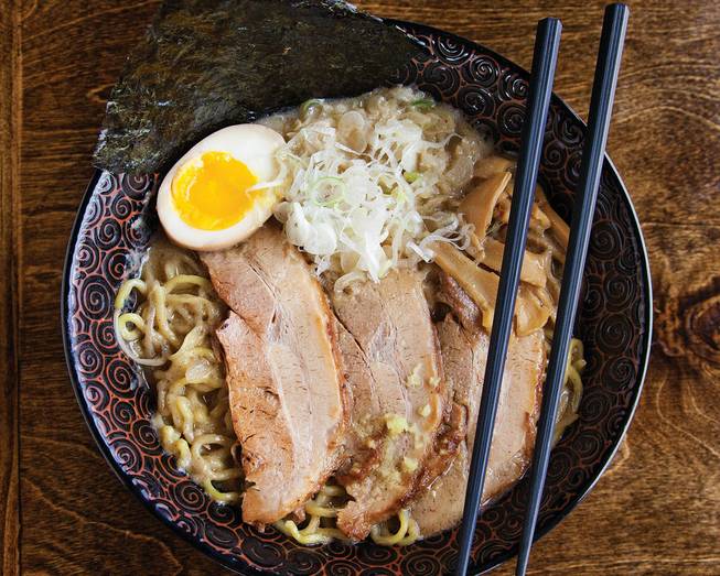 Ramen topped with pork, eggs, green onions and bamboo shoots.