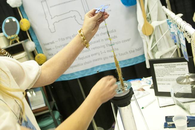 The Drain Chaingle For Showers, a device that collects hairs that normally clogs up the drain, is shown at the 2012 National Hardware Show in Las Vegas, Wednesday May 2, 2012.