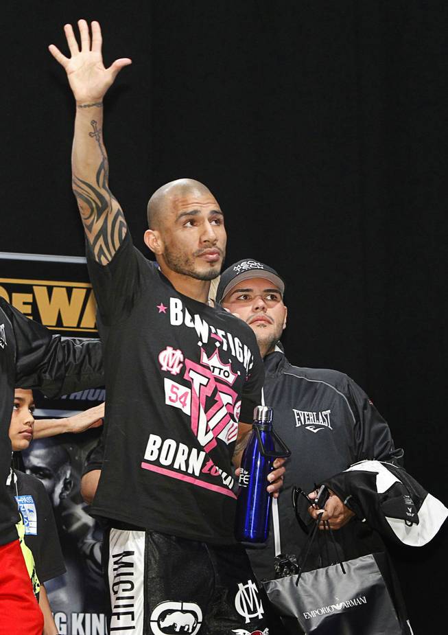 WBA super welterweight champion Miguel Cotto of Puerto Rico waves to fans as he leaves an official weigh-in at the MGM Grand Garden Arena Friday, May 4, 2012. Cotto will defend his title against Floyd Mayweather Jr. of the U.S.at the arena Saturday.
