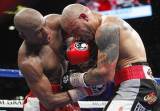 Floyd Mayweather Jr., left, battles it out with WBA super welterweight champion Miguel Cotto of Puerto Rico during their title fight at the MGM Grand Garden Arena Saturday, May 5, 2012.