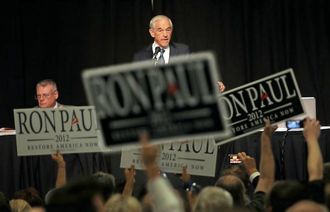Ron Paul supporters wave campaign signs at the Nevada state GOP convention at John Ascauaga's Nugget on Saturday, May 5, 2012.