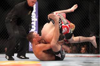 Nate Diaz, bottom, sinks in the fight-winning choke against Jim Miller during the second round of their lightweight bout at UFC on Fox at the Izod Center in E. Rutherford, N.J., on Saturday, May 5, 2012. Diaz won via tapout due to the choke in round 2.