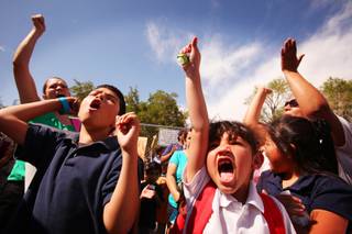 Third-grader Omar Gonzalez, left, 9 and first-grader Emelyn Martinez, 6, cheer during a protest outside of Vegas Verdes Elementary School on Monday, May 7, 2012.