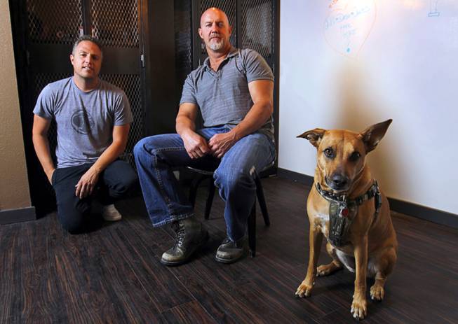 Chris Ramirez, left, founder, and Mark Balint, head of production, are shown in the Silver State Production Services offices in downtown Las Vegas Tuesday, May 8, 2012. Also pictured is Chris' dog Abby, a four-year-old Ridgeback-shepherd-lab mix.